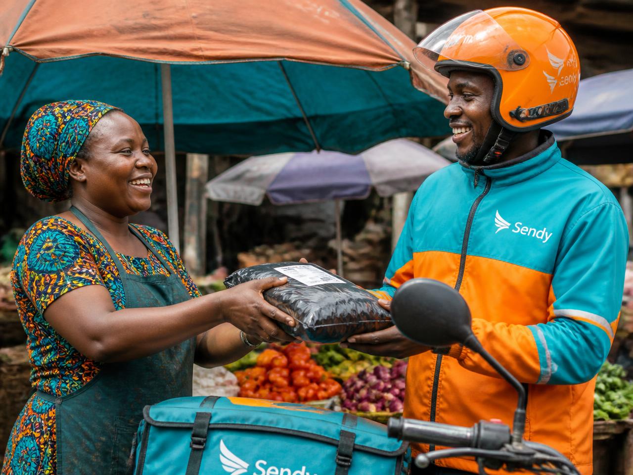 Market trader handing a parcel to a delivery rider